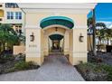 Elegant condo entrance featuring a covered walkway and detailed architectural elements, offering a welcoming and sophisticated arrival at 2161 Gulf Of Mexico Dr # 3, Longboat Key, FL 34228