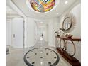 Grand foyer featuring a decorative ceiling and custom tile flooring, enhancing the condo's luxurious and artistic appeal at 2161 Gulf Of Mexico Dr # 3, Longboat Key, FL 34228