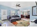 Inviting living room with blue walls, plush gray sectional, and a view into the connected sunroom at 2564 Wood St, Sarasota, FL 34237
