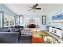 Comfortable living room featuring a plush sectional, bright walls, and an open layout leading to a sunroom at 2564 Wood St, Sarasota, FL 34237