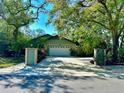 Charming single Gathering home with an attached two-car garage surrounded by mature trees at 3246 Maiden Ln, Sarasota, FL 34231