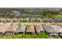 An aerial of a home showcases its tile roof and landscaping, nestled in a community near a serene pond and golf course at 3639 Santa Caterina Blvd, Lakewood Ranch, FL 34211