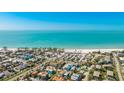 An aerial view showcasing the proximity of the property to a beautiful beach and the surrounding neighborhood at 4101 4Th Ave, Holmes Beach, FL 34217