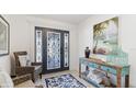 Welcoming foyer with decorative rug, console table, and a front door with custom glasswork at 4101 4Th Ave, Holmes Beach, FL 34217