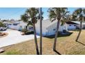 A single-story home shows the side yard and a glimpse of the driveway on a sunny day at 4120 Shamrock Dr, Venice, FL 34293