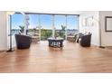 Inviting seating area with comfortable chairs, a glass coffee table, and floor-to-ceiling windows at 435 S Gulfstream Ave # 601, Sarasota, FL 34236