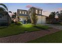 Charming two-story home features a well-manicured lawn, lush landscaping, and a spacious three-car garage at 5822 Title Row Dr, Bradenton, FL 34210