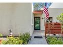 Inviting front entrance featuring a well-maintained walkway, fresh landscaping, and an American flag at 622 Spring Lakes Blvd, Bradenton, FL 34210