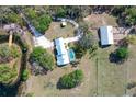 Aerial view of the home's layout, featuring a pool, barn, and dock access to the pond at 7108 229Th E St, Bradenton, FL 34211