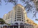 Stunning condo building with multiple balconies, street-level retail, and lush palm trees at 100 Central Ave # C521, Sarasota, FL 34236