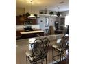 Inviting kitchen with granite countertops, stainless steel appliances, and an open dining area at 10157 Sunburst Ct, Spring Hill, FL 34608