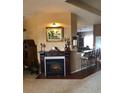 Cozy living room featuring a fireplace, neutral paint, and access to a breakfast bar at 10157 Sunburst Ct, Spring Hill, FL 34608
