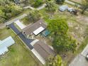 Aerial shot showcasing property, pool, blacktop drive, guest house and lush landscaping at 1210 67Th Street E Ct, Bradenton, FL 34208