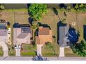 Aerial view of a home featuring a screened-in pool and fenced yard backing up to a waterway at 1224 Inverness St, Port Charlotte, FL 33952