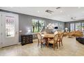 Bright living space with dining area, neutral tile flooring, and sun-filled windows at 12245 Marsh Pointe Rd, Sarasota, FL 34238