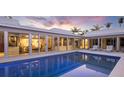 Stunning private pool area with elegant tiling, lounge chairs, and seamless indoor-outdoor living at 1354 Westway Dr, Sarasota, FL 34236