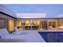 Relaxing poolside patio with lounge chairs and expansive windows offering views of the dining area at 1354 Westway Dr, Sarasota, FL 34236