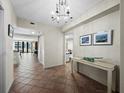 Inviting foyer with tile flooring and chandelier, offering a glimpse into the living spaces at 1485 Gulf Of Mexico Dr # 205, Longboat Key, FL 34228
