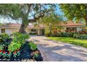 Single-story home with mature landscaping around the property at 1610 S Lake Shore Dr, Sarasota, FL 34231