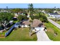 A captivating aerial view of a yellow home, showcasing the neighborhood and lush backyard at 2640 Geneva Rd, Venice, FL 34293