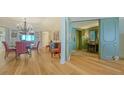 Inviting open-concept living area with beautiful hardwood floors and views of the foyer with its fireplace at 3040 Grand Bay Blvd # 234, Longboat Key, FL 34228
