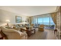 Comfortable living room with plush seating, area rug, and expansive windows showcasing stunning ocean views at 3040 Grand Bay Blvd # 234, Longboat Key, FL 34228