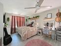 Cozy bedroom featuring a ceiling fan, soft lighting, and a vanity with a lighted mirror at 3307 3Rd W Ave, Bradenton, FL 34205