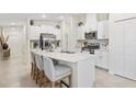 Modern kitchen featuring a large island, stainless steel appliances, and bright white cabinets at 3707 Ambersweet Crossing, Parrish, FL 34219