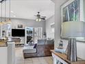 Comfortable living room with modern furnishings, tile flooring, and sliding glass doors to outdoor space at 3826 Virga Blvd, Sarasota, FL 34233