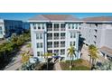 Gorgeous condo exterior featuring private balconies, lush landscaping, and coastal charm at 396 Aruba Cir # 302, Bradenton, FL 34209
