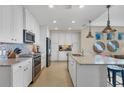 Modern kitchen features stainless steel appliances, white cabinetry, and an open layout at 396 Aruba Cir # 302, Bradenton, FL 34209