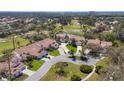 Aerial view of golf course community featuring lush greenery and serene water features with red tile roofs at 4416 Calle Serena, Sarasota, FL 34238