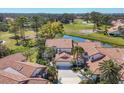 Beautiful aerial view of a residential area with golf course views and well-manicured landscaping and red tile roofs at 4416 Calle Serena, Sarasota, FL 34238
