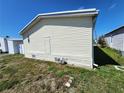 Exterior elevation showing the side of the home with a utility access panel at 4923 5Th Street W Ct, Bradenton, FL 34207