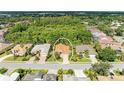 Aerial view of a single story home surrounded by lush landscaping and other homes in the neighborhood at 5308 88Th E St, Bradenton, FL 34211