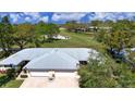 Overhead shot of the home, showcasing its location near a lush golf course and landscaping at 5621 Palm Aire Dr, Sarasota, FL 34243