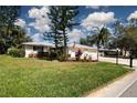 This lovely home boasts a well-manicured lawn and colorful landscaping, with a two-car garage at 5621 Palm Aire Dr, Sarasota, FL 34243