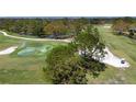 Scenic view of the golf course with a water hazard and pristine green grass at 5621 Palm Aire Dr, Sarasota, FL 34243