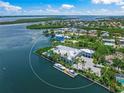 Stunning waterfront home with a boat dock surrounded by lush foliage in a charming coastal community at 612 Juan Anasco Dr, Longboat Key, FL 34228