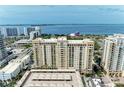 Beautiful facade of a yellow high-rise building featuring numerous balconies with expansive ocean views at 750 N Tamiami Trl # 814, Sarasota, FL 34236