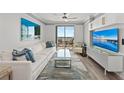 Bright living room features modern furnishings, a plush sofa, and a sliding door to a balcony at 750 N Tamiami Trl # 814, Sarasota, FL 34236