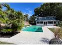 Refreshing pool with lush landscaping, surrounded by a concrete patio perfect for outdoor relaxation and entertaining at 7735 Westmoreland Dr, Sarasota, FL 34243