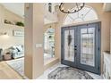 The home's foyer features tile flooring, a chandelier, and an open floor plan to the living area at 9317 Saint Paul Drive, Port Charlotte, FL 33981