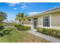 Image shows a well-maintained exterior with a view of the adjacent pond and lush green lawn at 9847 Hawk Nest Ln, North Port, FL 34287