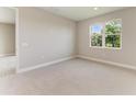 Neutral bedroom with a carpet floor, one window providing natural light and a view of surrounding foliage at 995 Waterline Ct, Sarasota, FL 34240