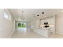 Bright living room features an open floor plan, neutral tones, tile flooring, and a sliding door at 995 Waterline Ct, Sarasota, FL 34240
