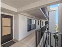 Condo hallway with access to unit door, window, and a view of the outside at 1001 Benjamin Franklin Dr # 510, Sarasota, FL 34236