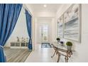 Inviting foyer with tile flooring, elegant decor, and a view of the front door at 10179 Milky Way Cir, Sarasota, FL 34241