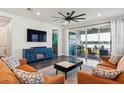 Inviting living room with modern decor and sliding doors to patio at 11659 Little River Way, Parrish, FL 34219
