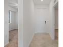 Hallway featuring tile flooring and access to a bedroom, showcasing the home's layout at 12180 Wellen Golf St # 302, Venice, FL 34293